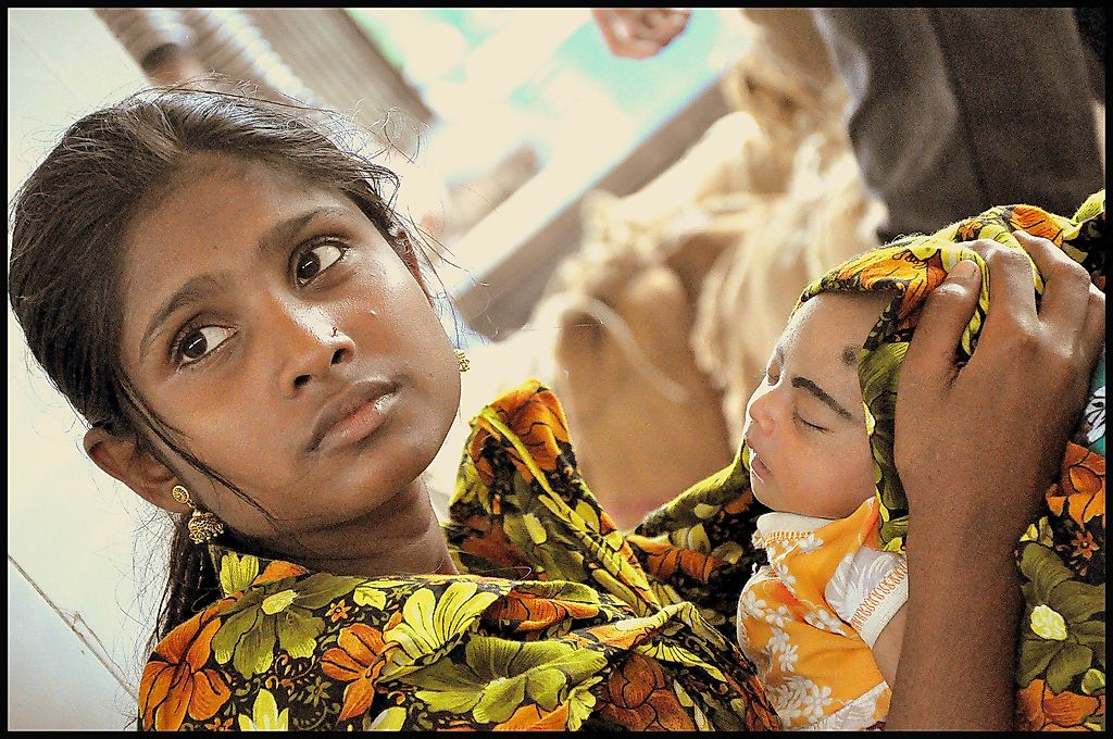 A  young married girl with her new born child.