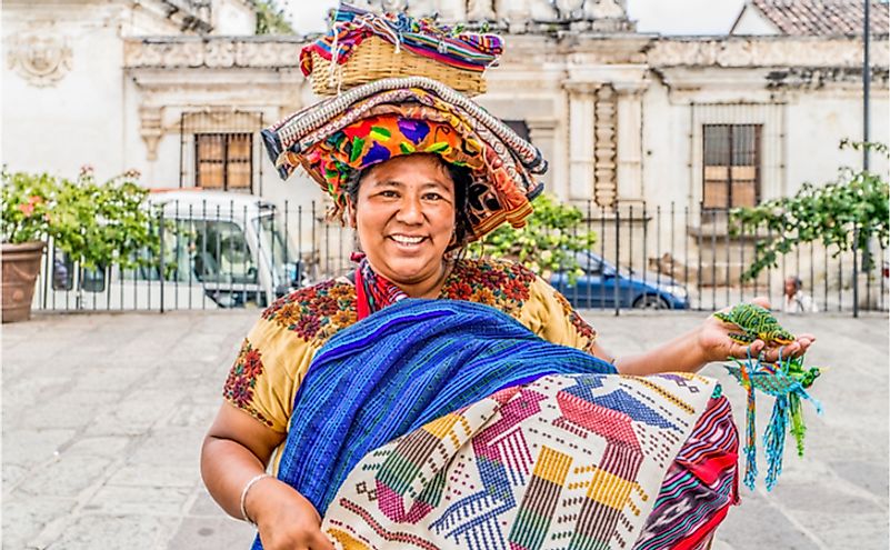 Indigenous Mayan market women sell handicrafts to international tourists in Puerto Quetzal, Guatemala. Editorial credit: Tony Moran / Shutterstock.com