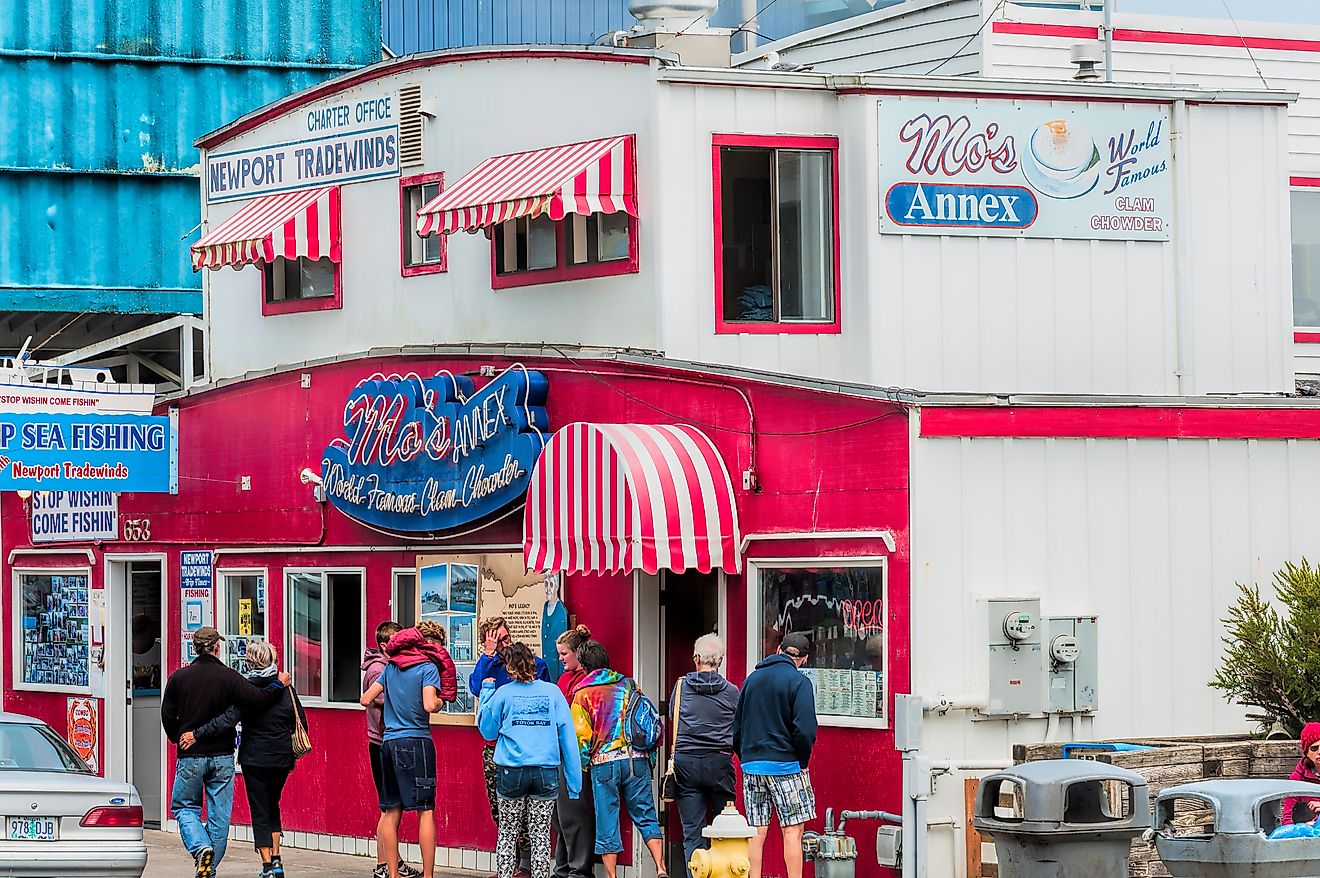 Dee Browning via Shutterstock. Newport, Oregon,USA - August 23, 2015:  Tourist stand in front of Moe's seafood annex in downtown Newport.