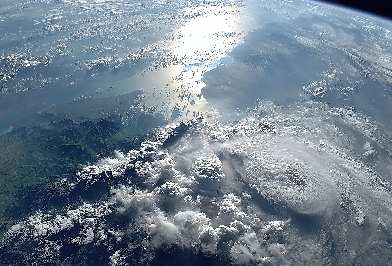 A stunning view of Earth from space, showcasing the vastness of the ocean and the intricate patterns of clouds illuminated by the sun.