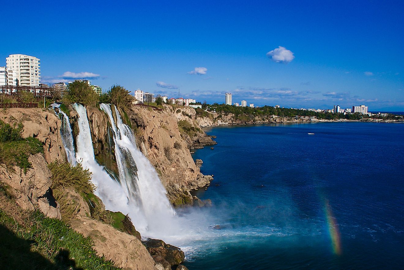 Lower Düden waterfall and rainbow formed over the sea. Photo from Antalya, Turkey. Image credit: mapsandphotos/Shutterstock.com