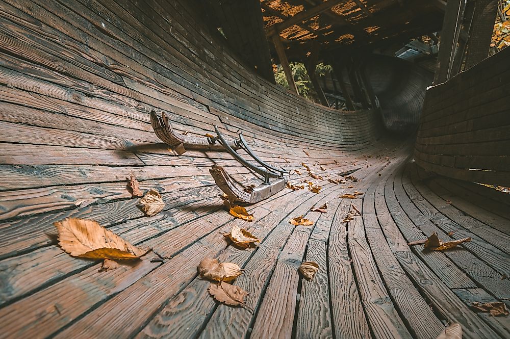 Abandoned luge track in pine woods.