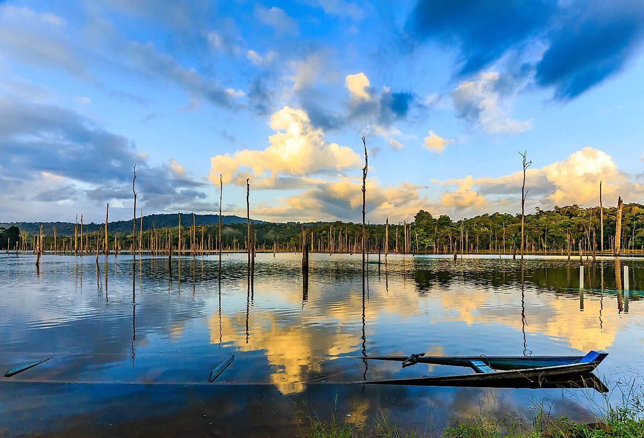 Lake Brokopondo in Suriname. Sunken canoe and reflection of sky in water. Image credit Rene via Shutterstock.