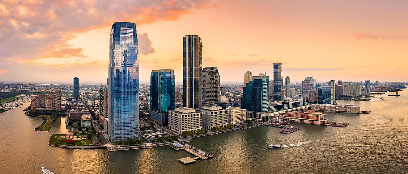 Aerial panorama of Jersey City skyline at sunset.