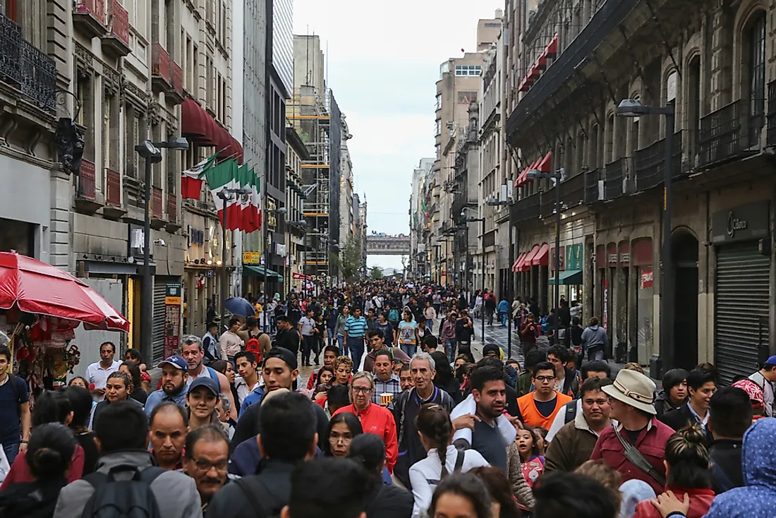 People walk down a busy street in Mexico. Editorial credit: EddieHernandezPhotography / Shutterstock.com.