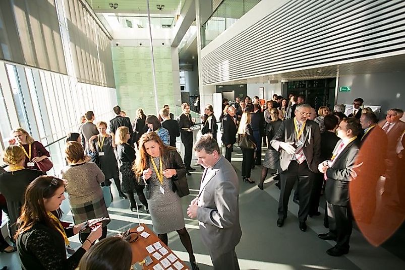 Family businesses and new startup entrepreneurs discuss ideas at a small business expo in Slovenia.