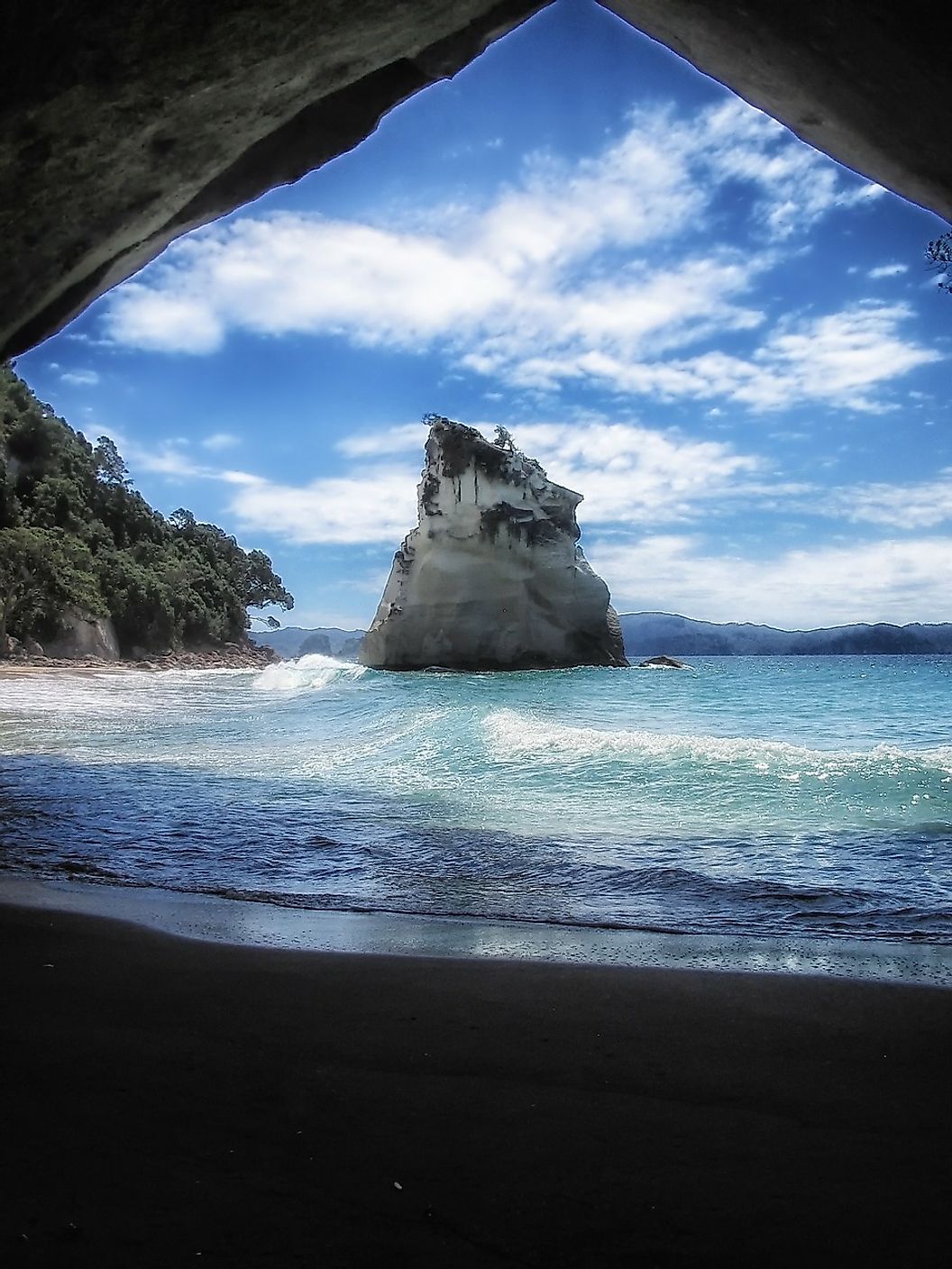A view of Cathedral Cove's gentle waves and blue waters, along with the rock formations which much of its wildlife also call home.