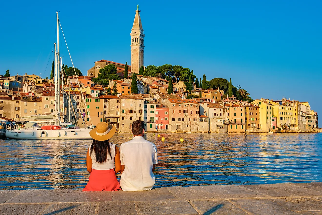 A couple relaxes by the water in the friendly town of Rovinj, Croatia, via Shutterstock user fokke barrssen.