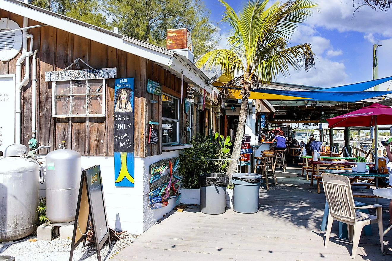 People enjoying the fresh seafood at a waterfront fish restaurant at Cortez, Florida