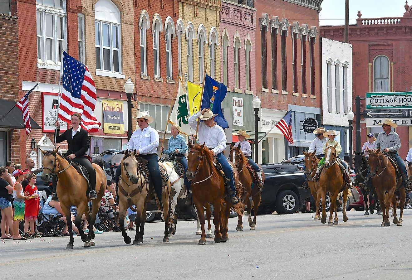Members of the Local 4 H club ride their horses on Main Street in the Washunga Days Parade in Council Grove, Kansas. Image credit mark reinstein via Shutterstock