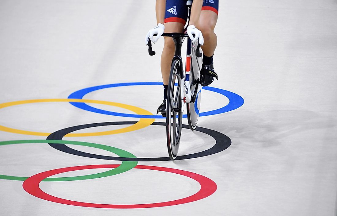 Cycling athlete crosses the Olympic ring. Credit: Shahjehan / Shutterstock.com