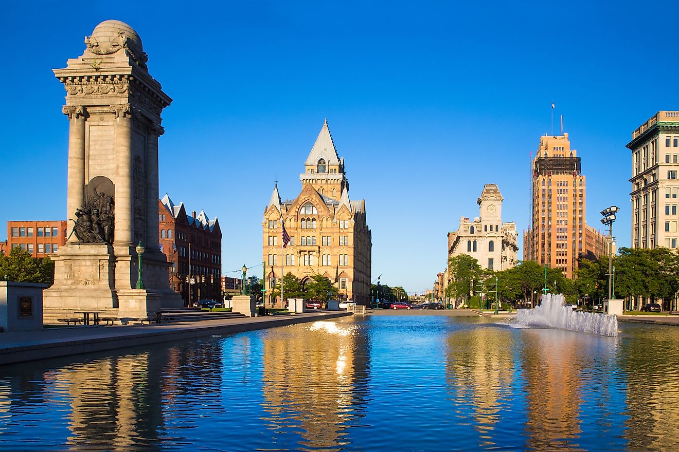 Downtown Syracuse New York with view of historic buildings and fountain at Clinton Square.