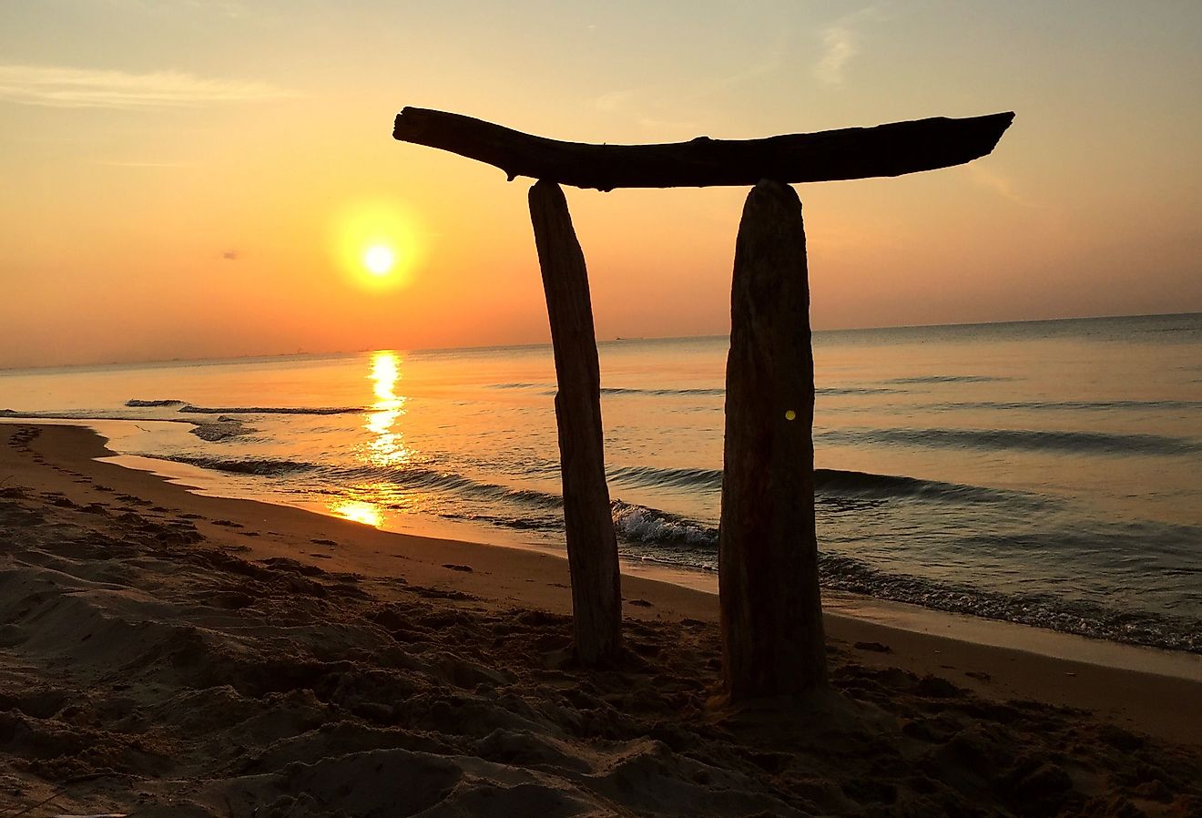 Wooden arch on the sunset beaches of Lake Michigan. Image credit Tommy Images via Shutterstock.