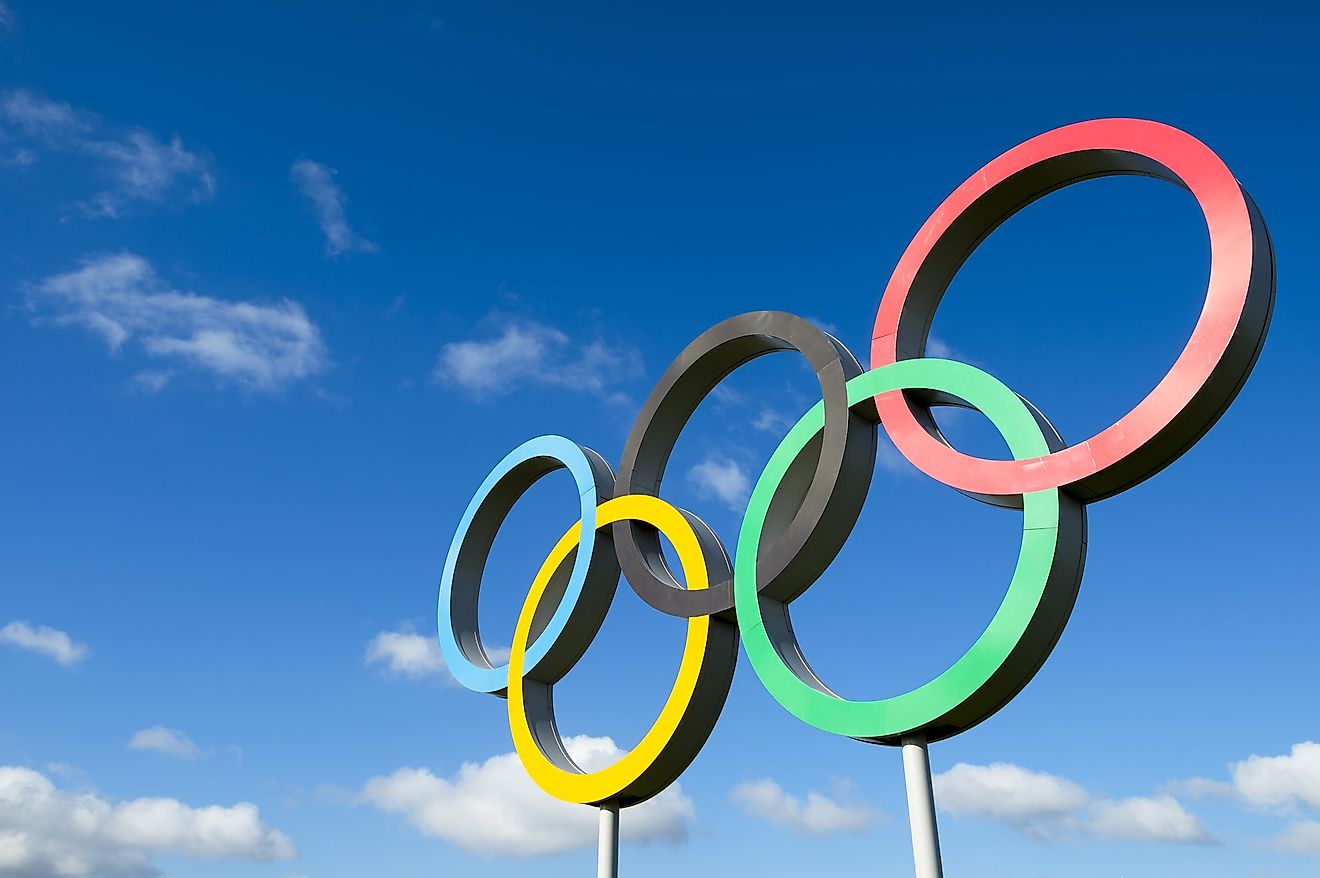  Olympic rings stand under bright blue sky in the Queen Elizabeth Olympic Park. Credit: lazyllama / Shutterstock.com