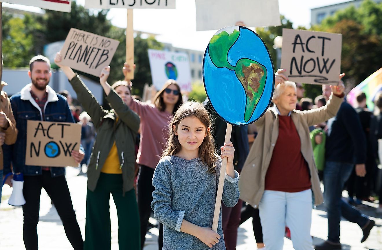 People with placards and posters on global strike for climate change. Image credit: Halfpoint/Shutterstock.com