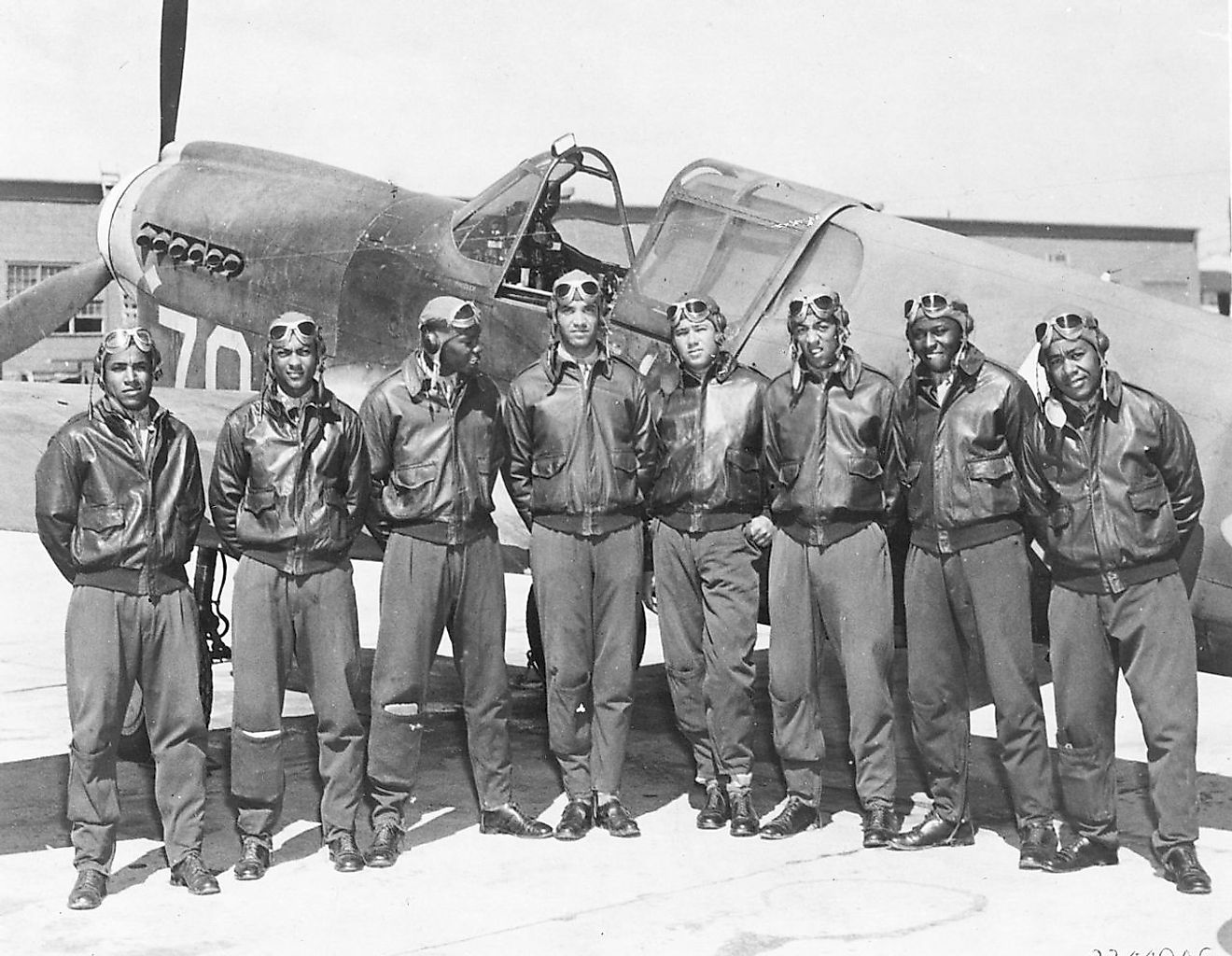 More details Eight Tuskegee Airmen in front of a P-40 fighter aircraft. Image credit: