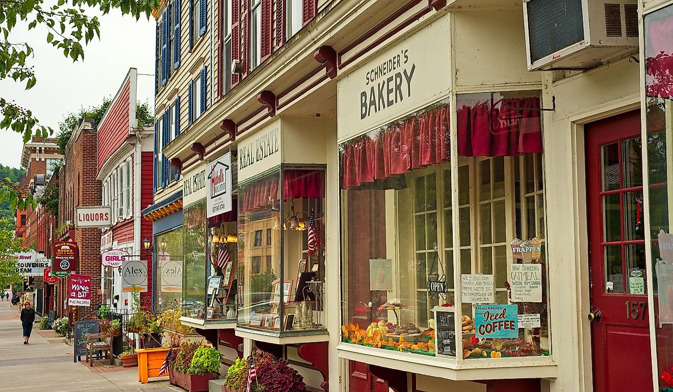 Shops, eateries, and baseball-themed attractions line the sidewalk on Main Street in Cooperstown, New York. Editorial credit: Kenneth Sponsler / Shutterstock.com