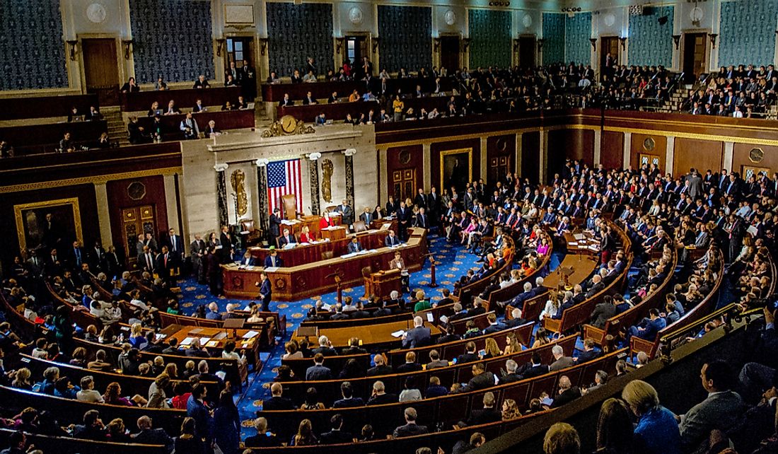 Members of Congress mingle on the house floor. Editorial credit: mark reinstein / Shutterstock.com