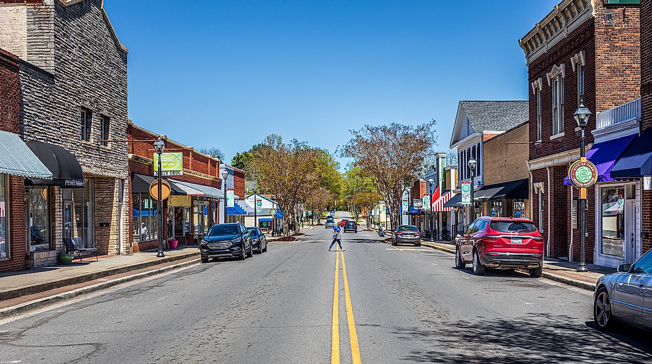 York, South Carolina: Wide angle view down North Congress Street on a sunny, blue sky, spring day. Woman crossing street.