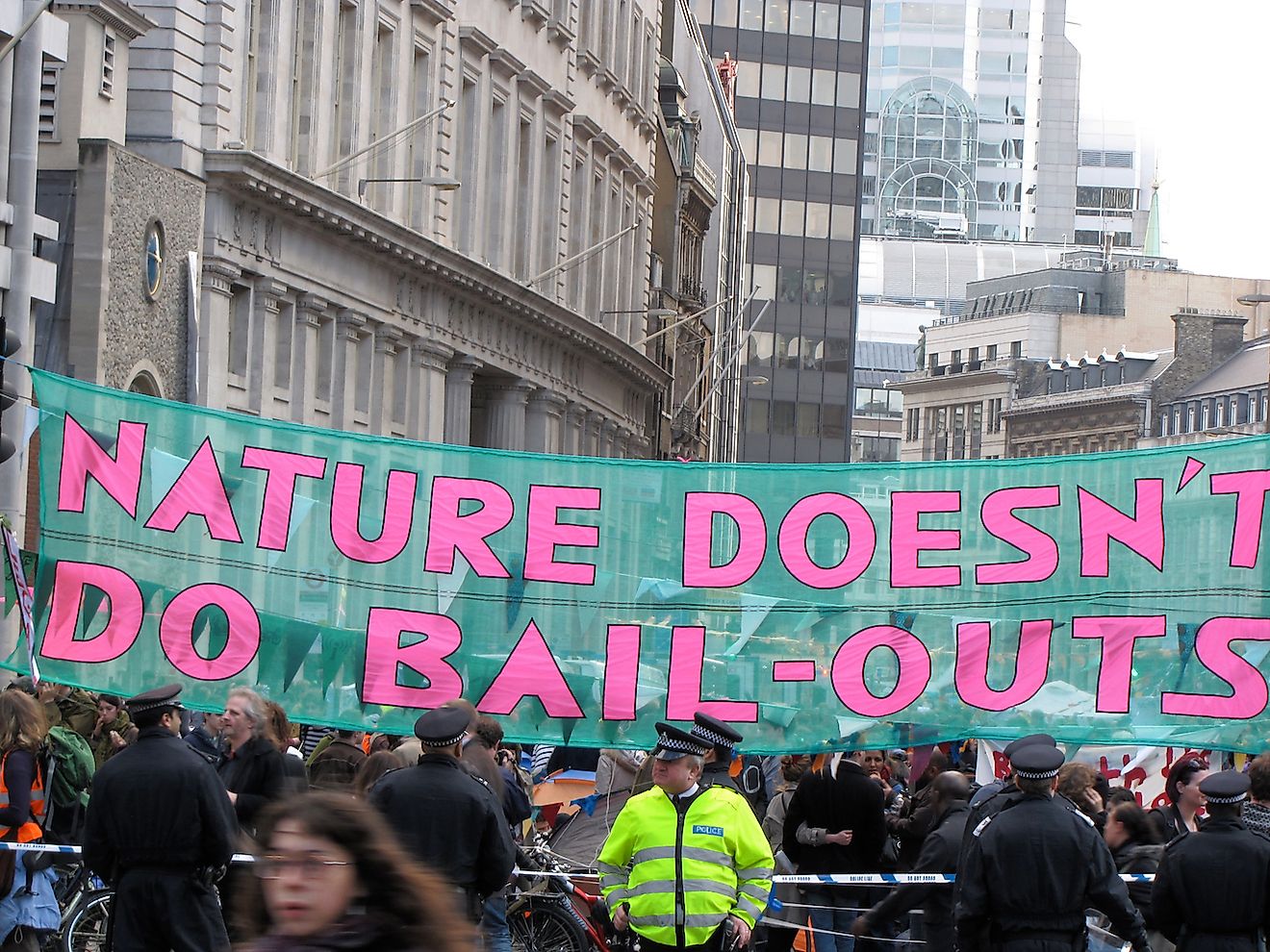 London / UK - April 1st 2009: Banner reading "Nature Doesn't Do Bailouts" strung across Bishops Gate in Central London during protests about the G20 summit. Image credit: Heardinlondon/Shutterstock.com