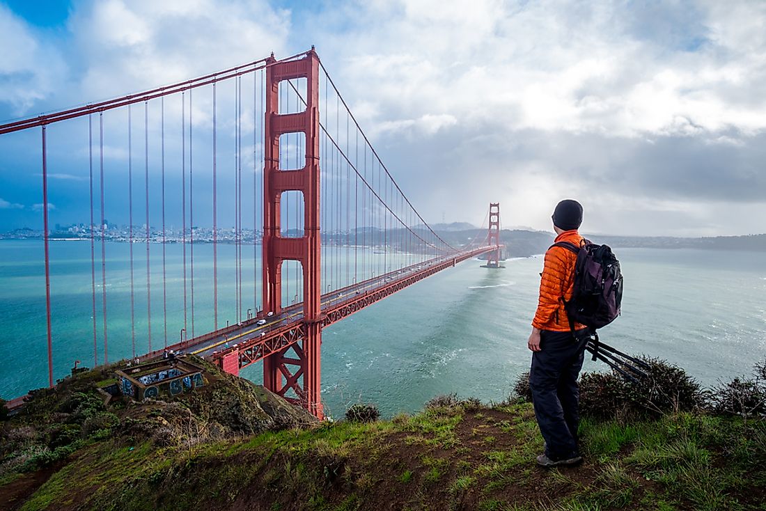 A traveler looking out at the Golden Gate Bridge, California. 