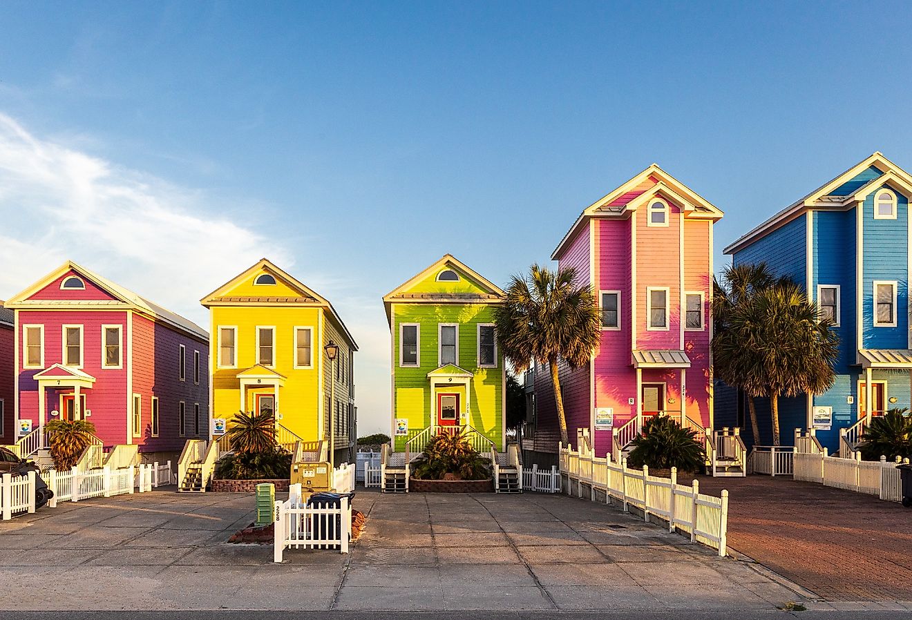 A row of colorful beachfront homes on a beautiful afternoon on St George Island, Florida. Image credit H.J. Herrera via Shutterstock