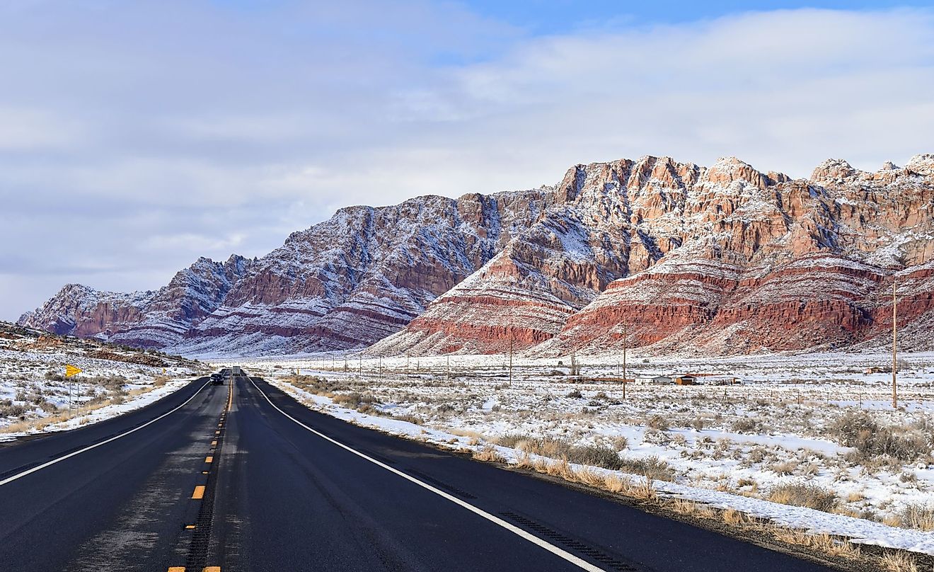 Highway 89 in the Painted Desert in northern Arizona with light snow on the hills. 