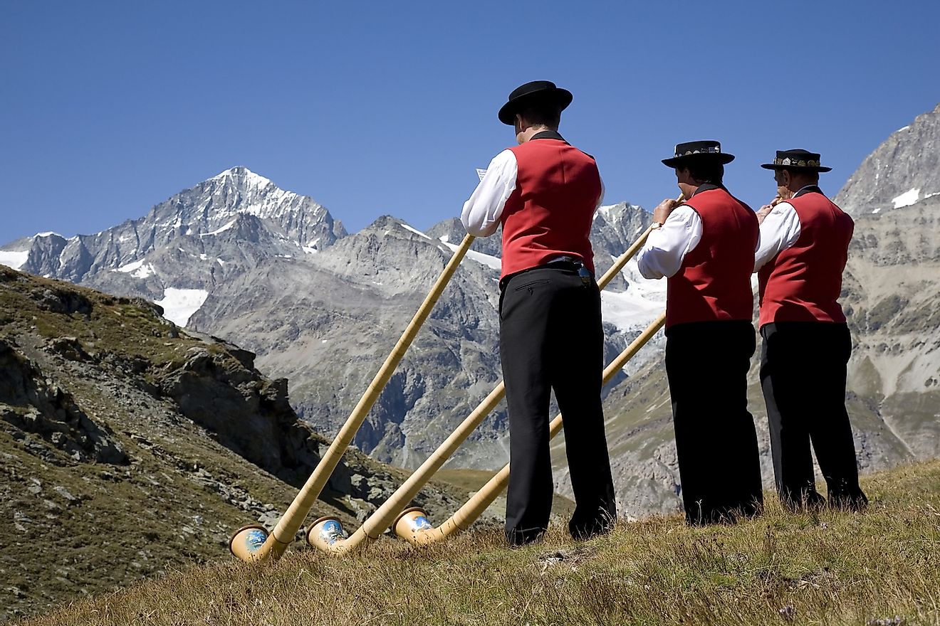 Swiss men playing the traditional trumpet. Image credit:  Avatar_023/Shutterstock.com