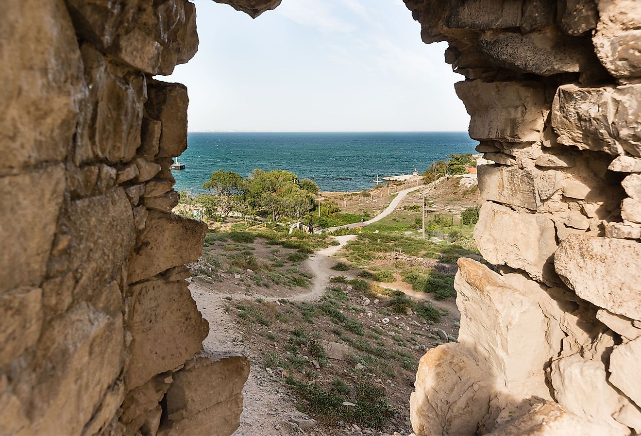 View from the window of the Krisko defensive tower of the medieval fortress of Kafa on the shore of the Gulf of Feodosia. Image credit Garmasheva Natalia via Shutterstock.