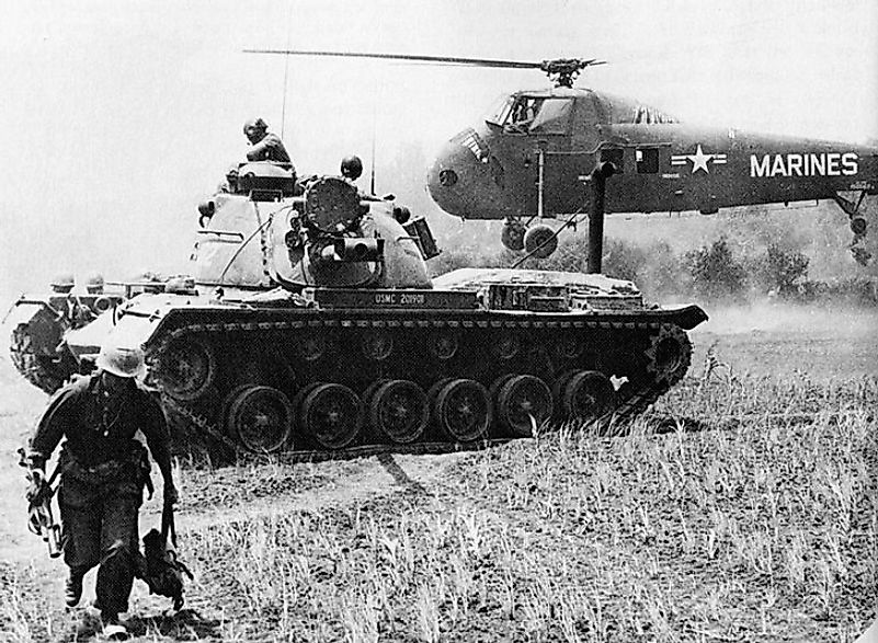 A tank and helicopter removing wounded U.S. Marines from the battlefield and carrying them to military hospital units during the Battle Of Van Tuong.