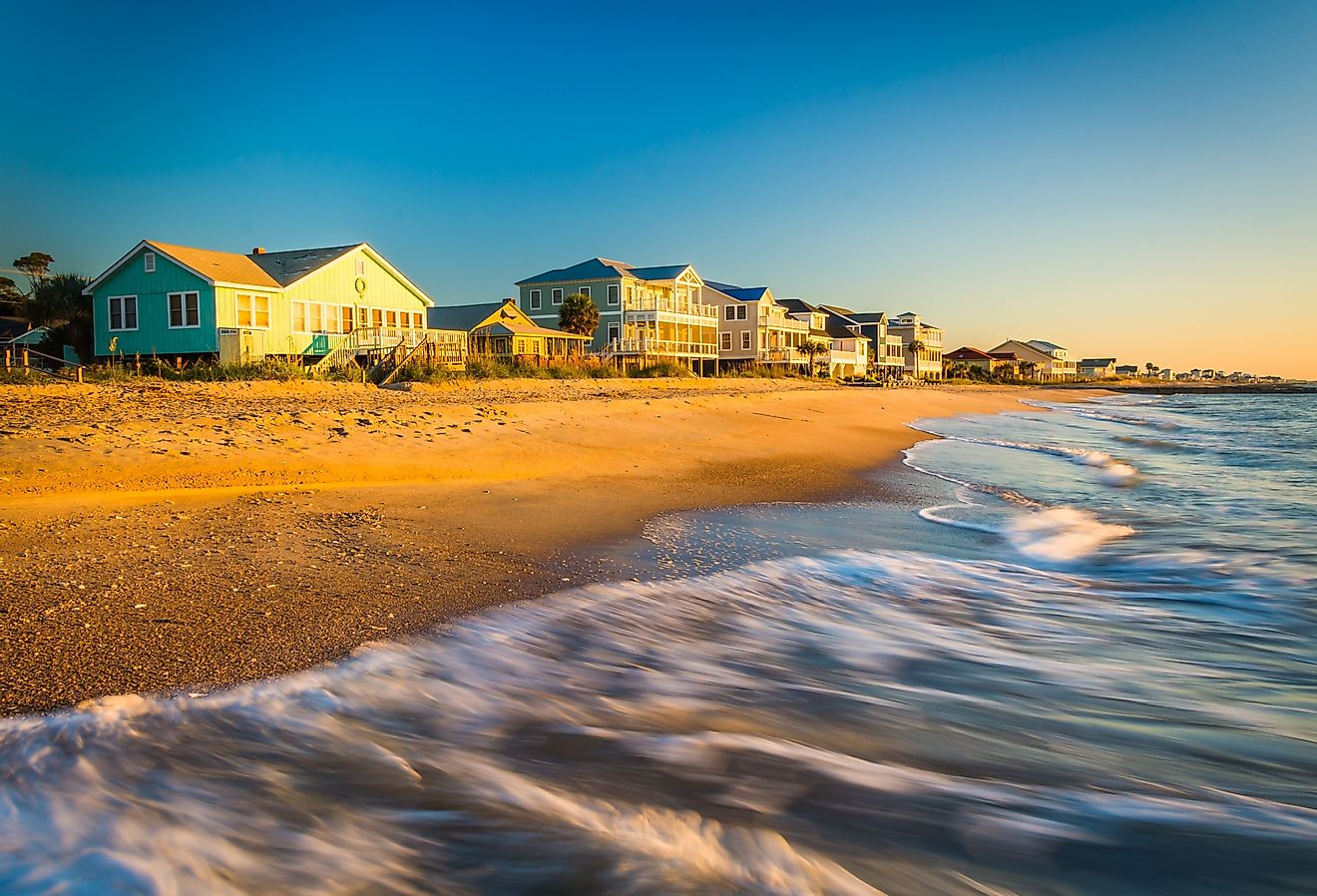 Waves in the Atlantic Ocean and morning light on beachfront homes at Edisto Beach, South Carolina.