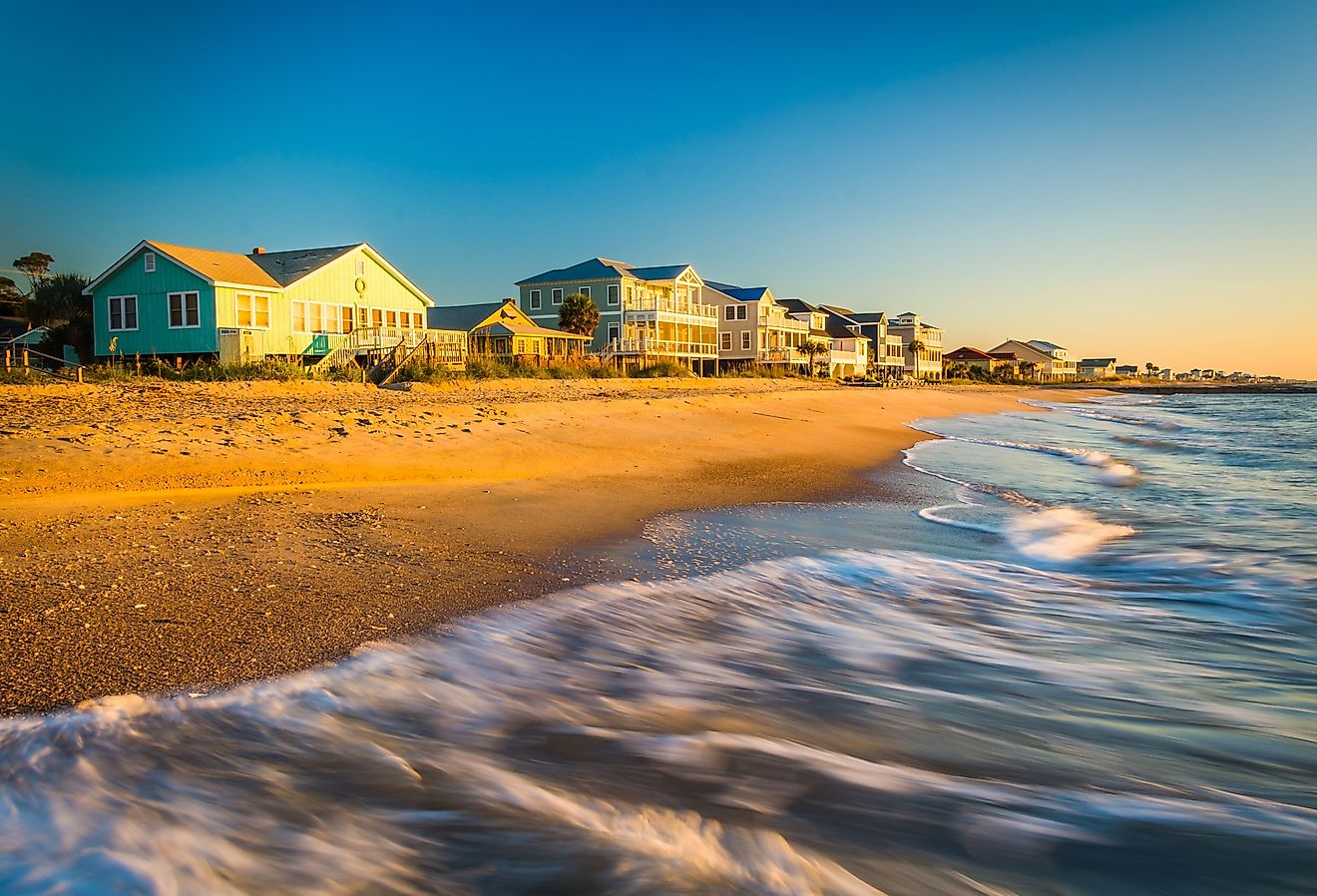 Waves in the Atlantic Ocean and morning light on beachfront homes at Edisto Beach, South Carolina.