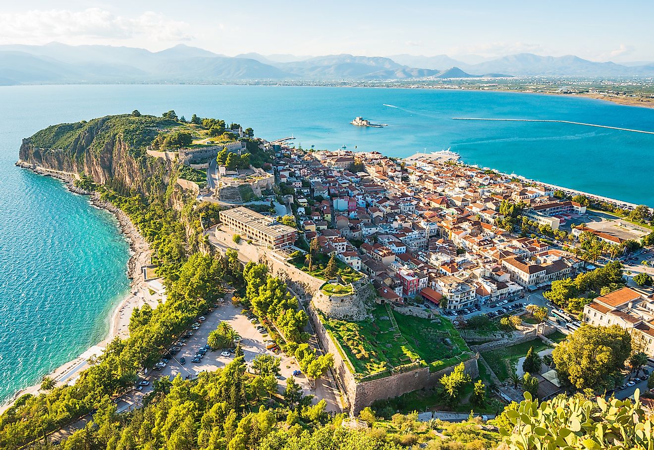 Green peninsula with Nafplion city in Greece. Image credit: Olga Kot Photo/Shutterstock.com