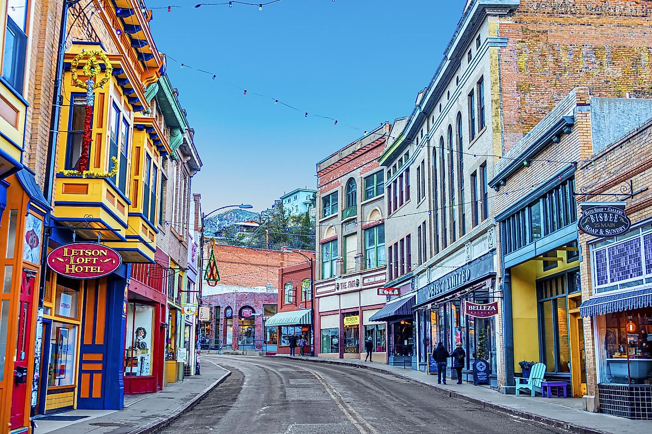 Buildings lining Main Street on a clear day at the edge of Bisbee, Arizona
