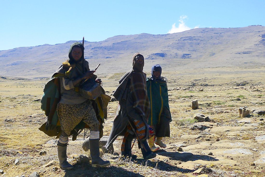 Men walk through rural Lesotho. Editorial credit: Leonard Zhukovsky / Shutterstock.com. 