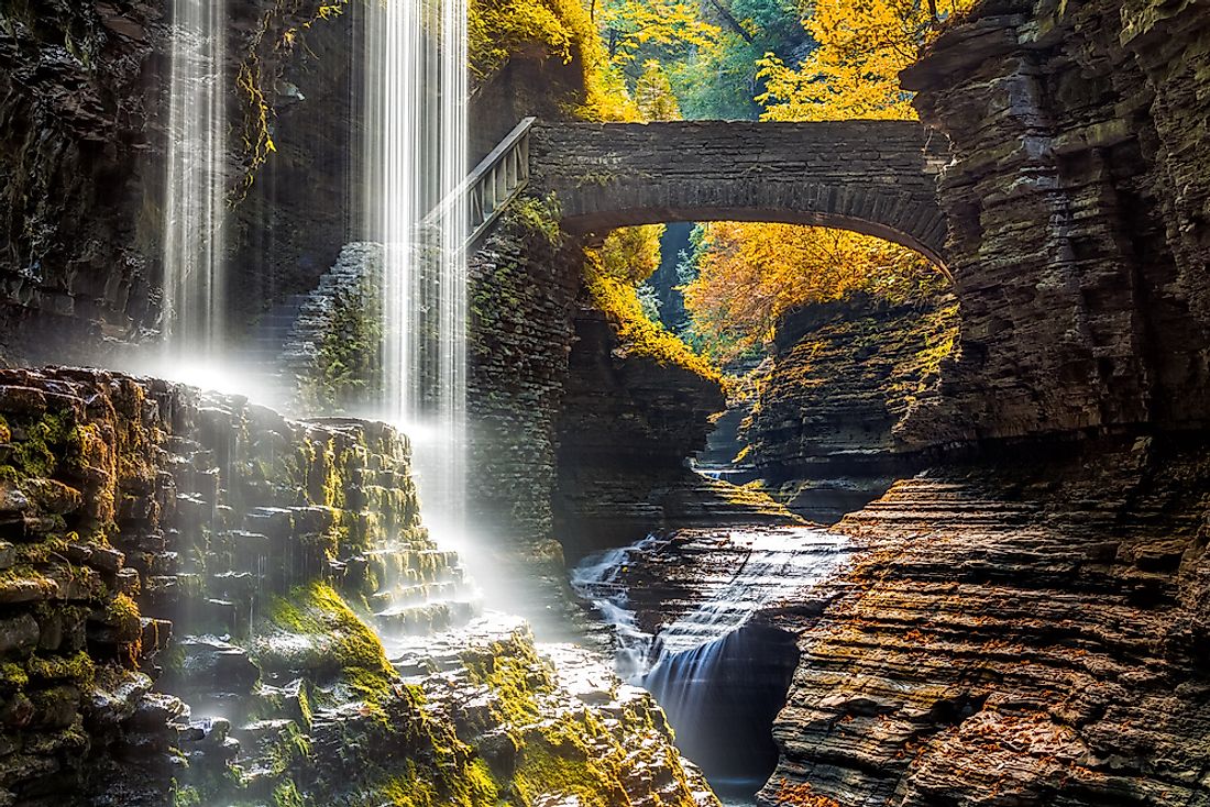 Rainbow Falls in Watkins Glen State Park. The steps leading up to Rainbow Bridge and the bridge itself are seen in the background.