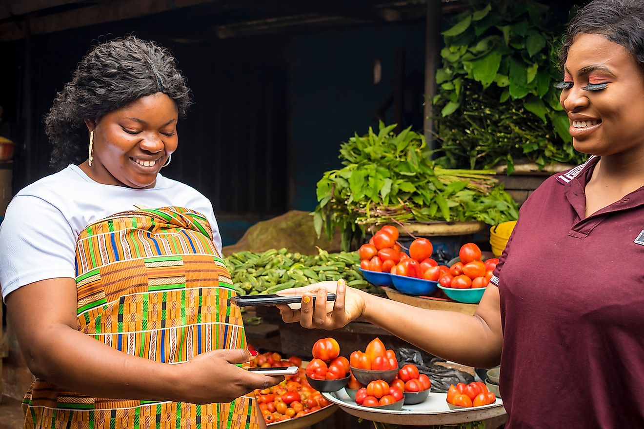 Women in Africa doing cashless transaction using smartphones. Image credit: i_am_zews/Shutterstock.com