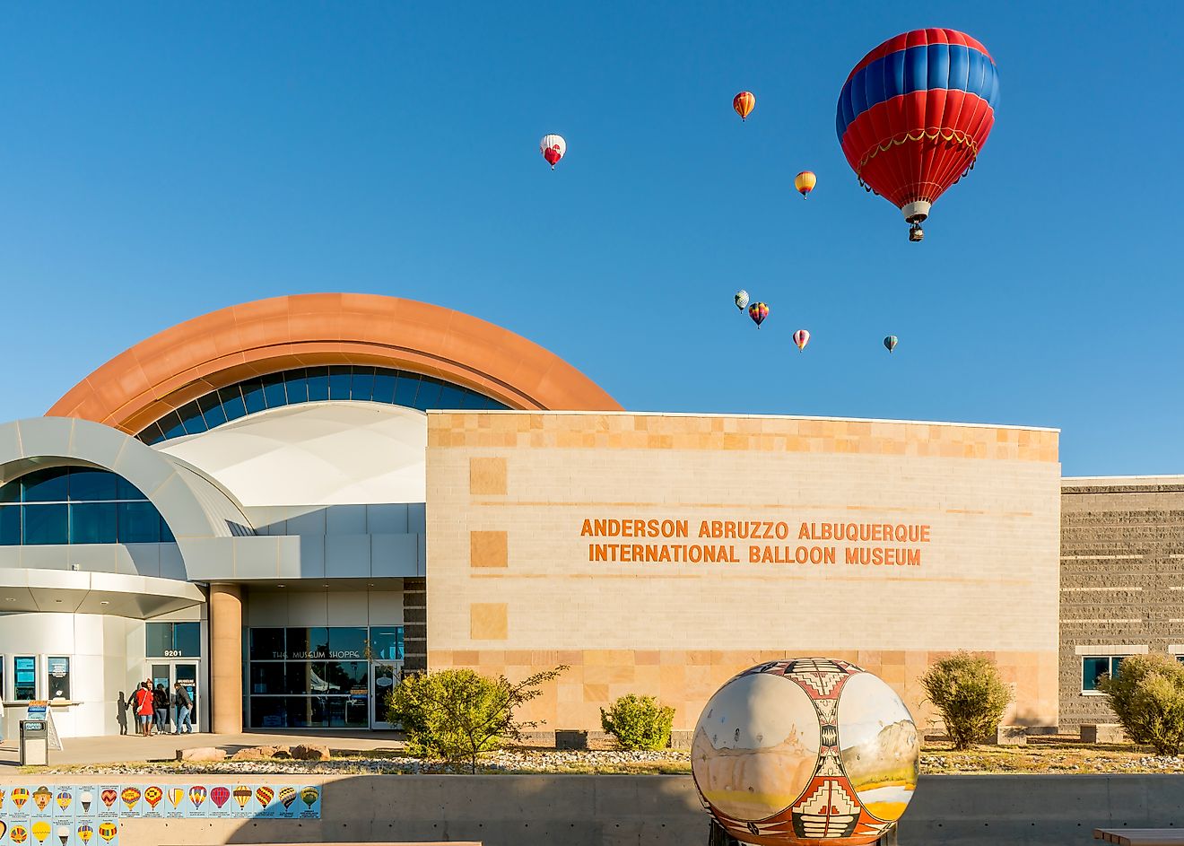 Colorful hot air balloons floating above the Anderson Abruzzo Albuquerque International Balloon Museum. Editorial credit: Steve Lagreca / Shutterstock.com.