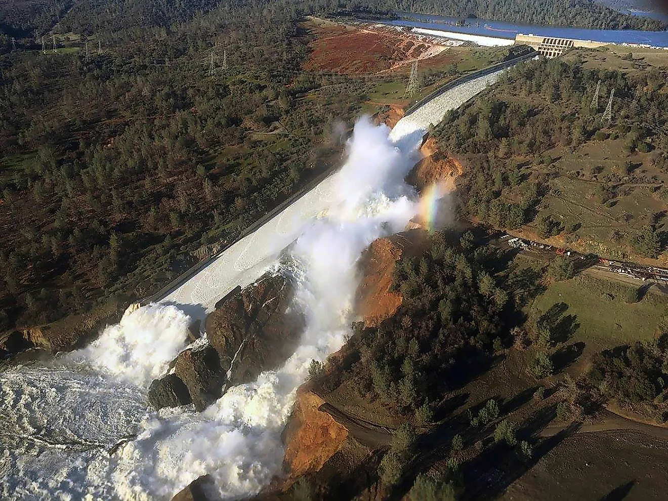 View of Oroville Dam's main spillway (center) and emergency spillway (top) collapsing. 