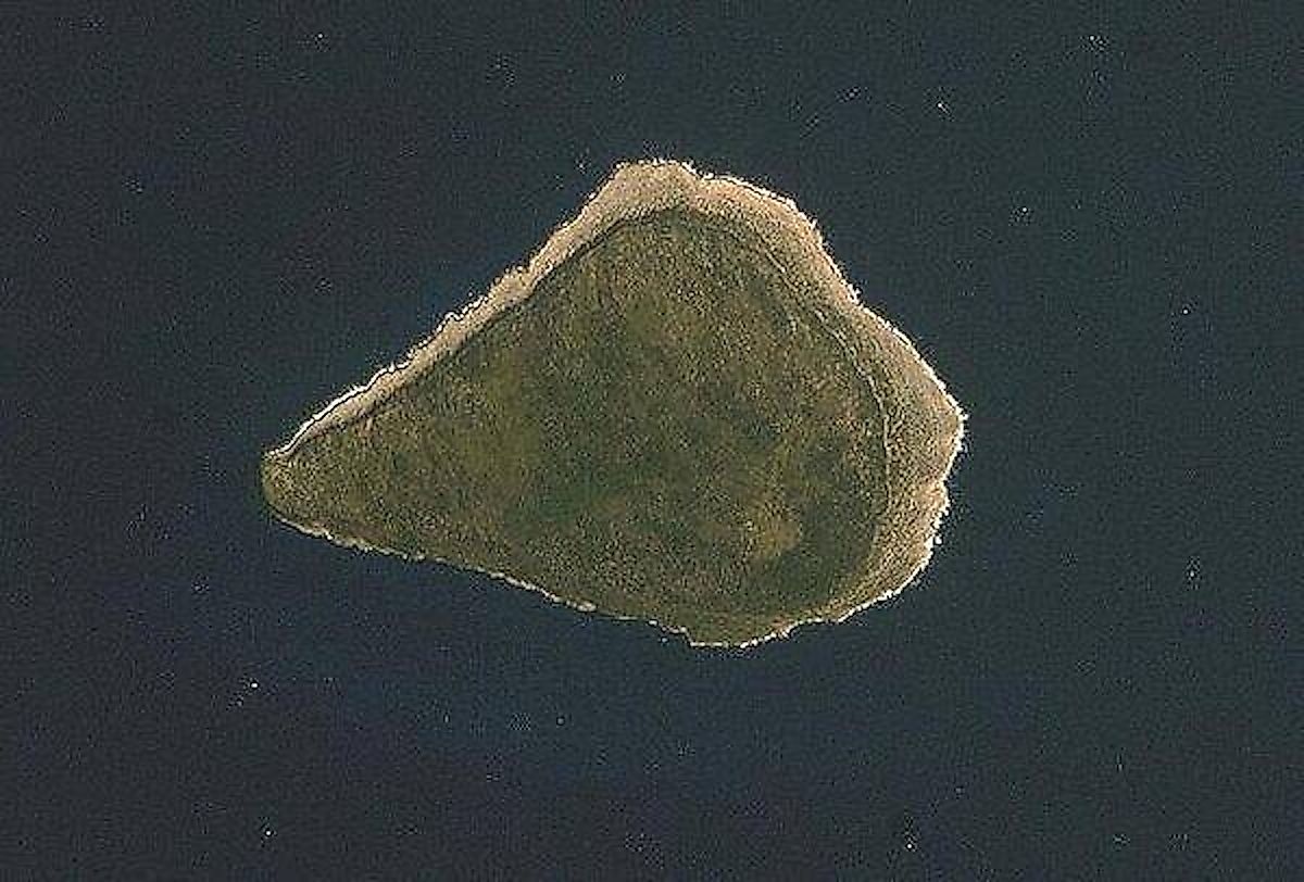 Astronaut photo of teardrop-shaped Navassa Island. The island is basically a plateau encircled by fairly steep cliffs.