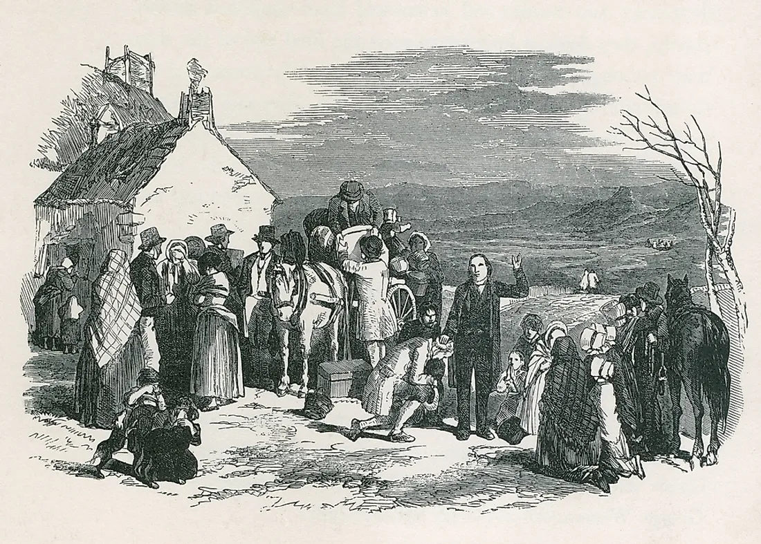 An Irish priest blesses immigrants who are fleeing their homes from the potato famine. 