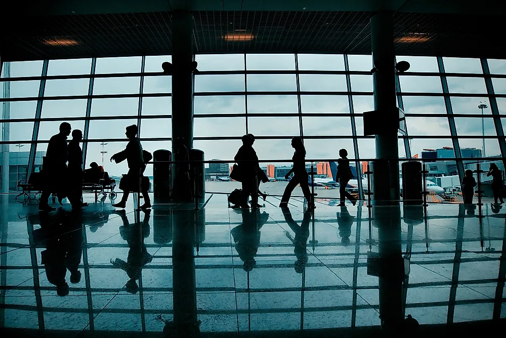 Travelers pass by with luggage at Sheremetyevo International Airport in Moscow. 