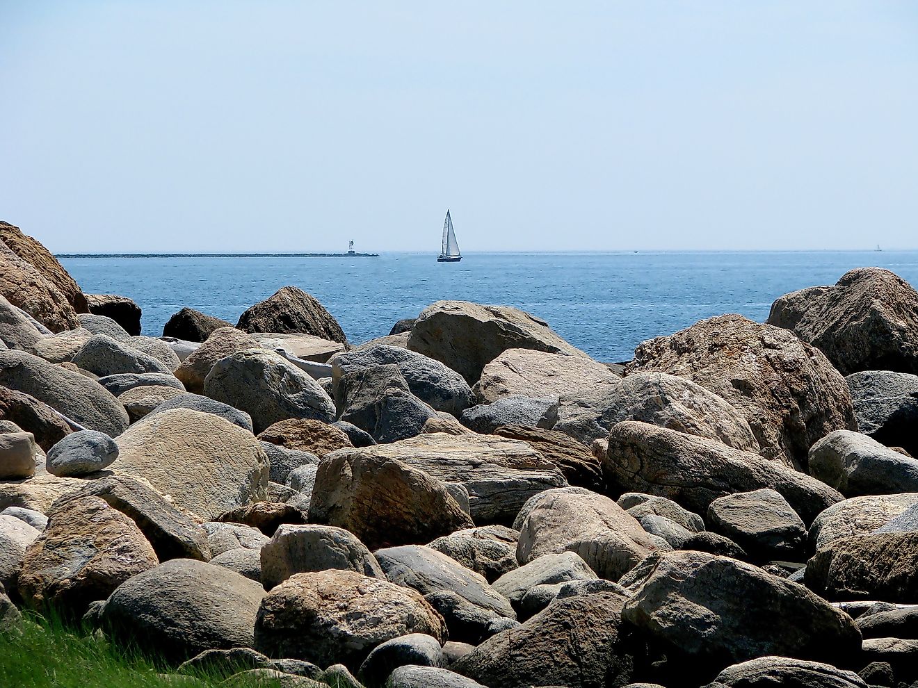 Hammonasset Beach State Park in Madison, Connecticut with sailboat in the background. 