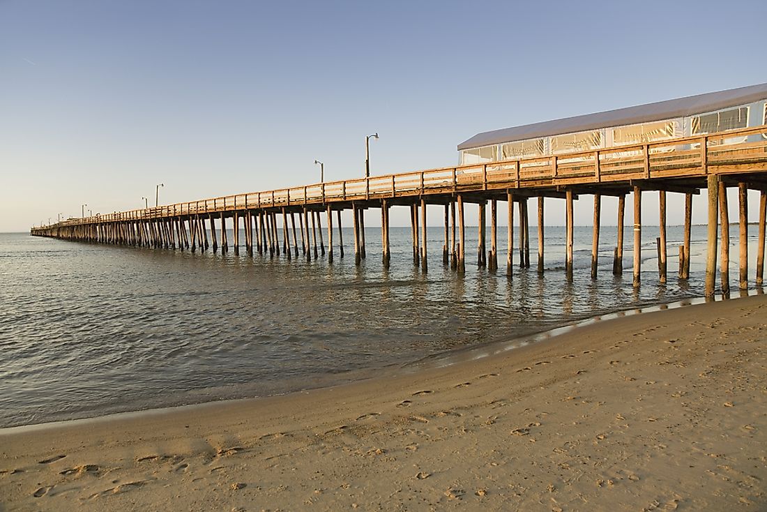 The Virginia Beach Pier extends from the shoreline out into and over the Atlantic Ocean.