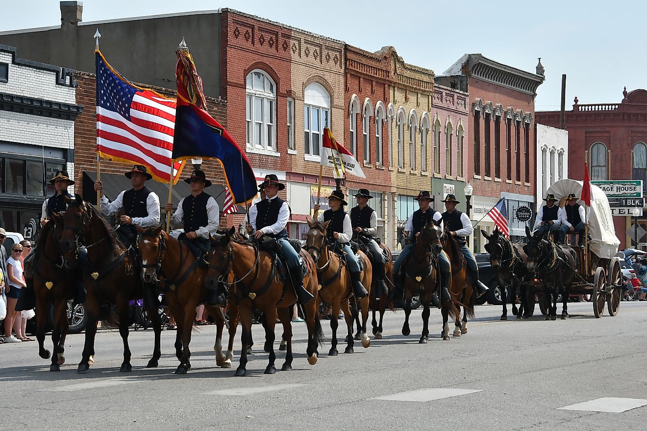Members of the Fort Riley Commanding General's Mounted Color Guard, outfitted in the uniforms and equipment of the Civil War, ride in the Washunga Days Parade in Council Grove, Kansas, USA. Editorial credit: mark reinstein / Shutterstock.com