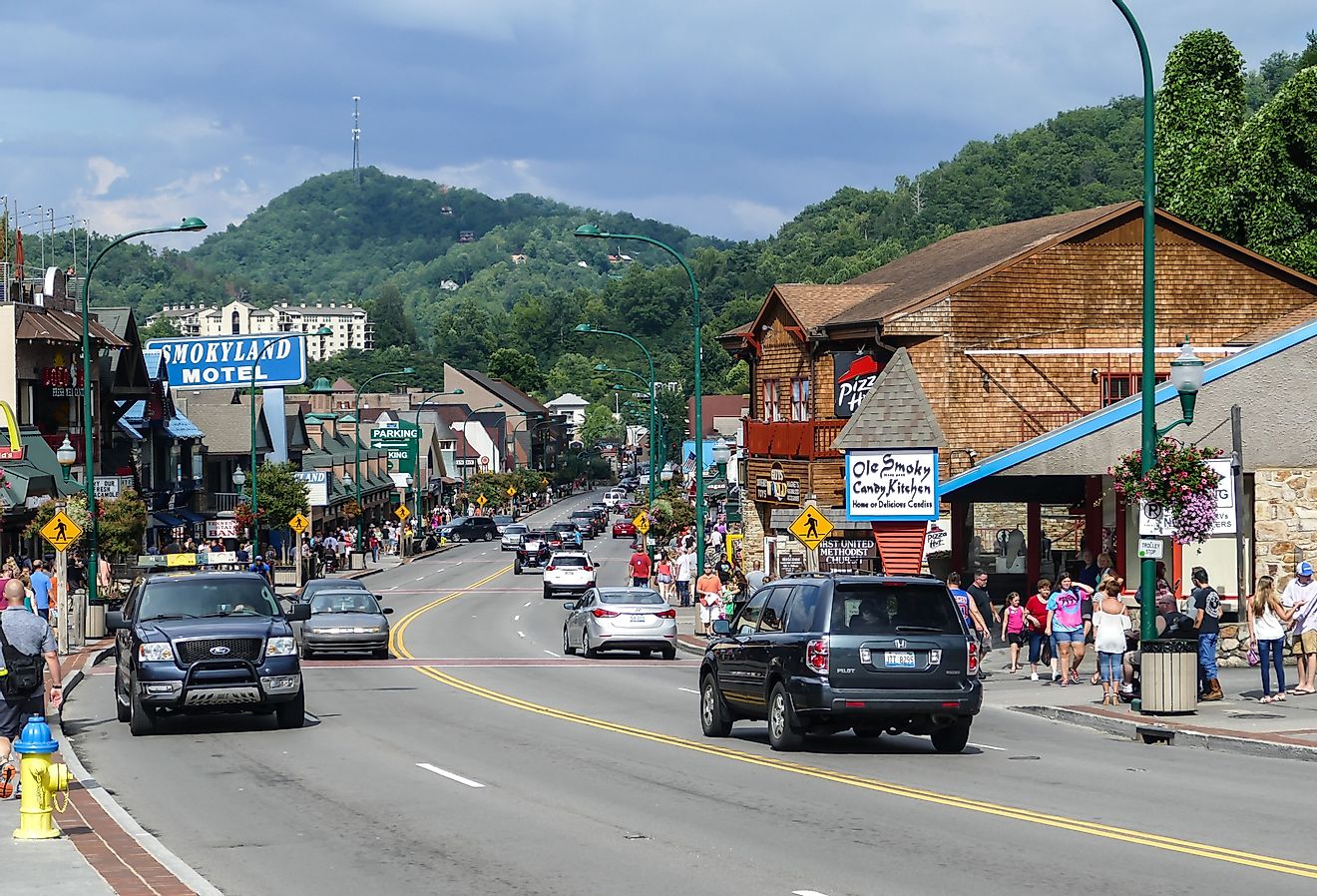 Busy street in summer time with tourist and car in Gatlinburg, Tennessee. Image credit Miro Vrlik Photography via Shutterstock