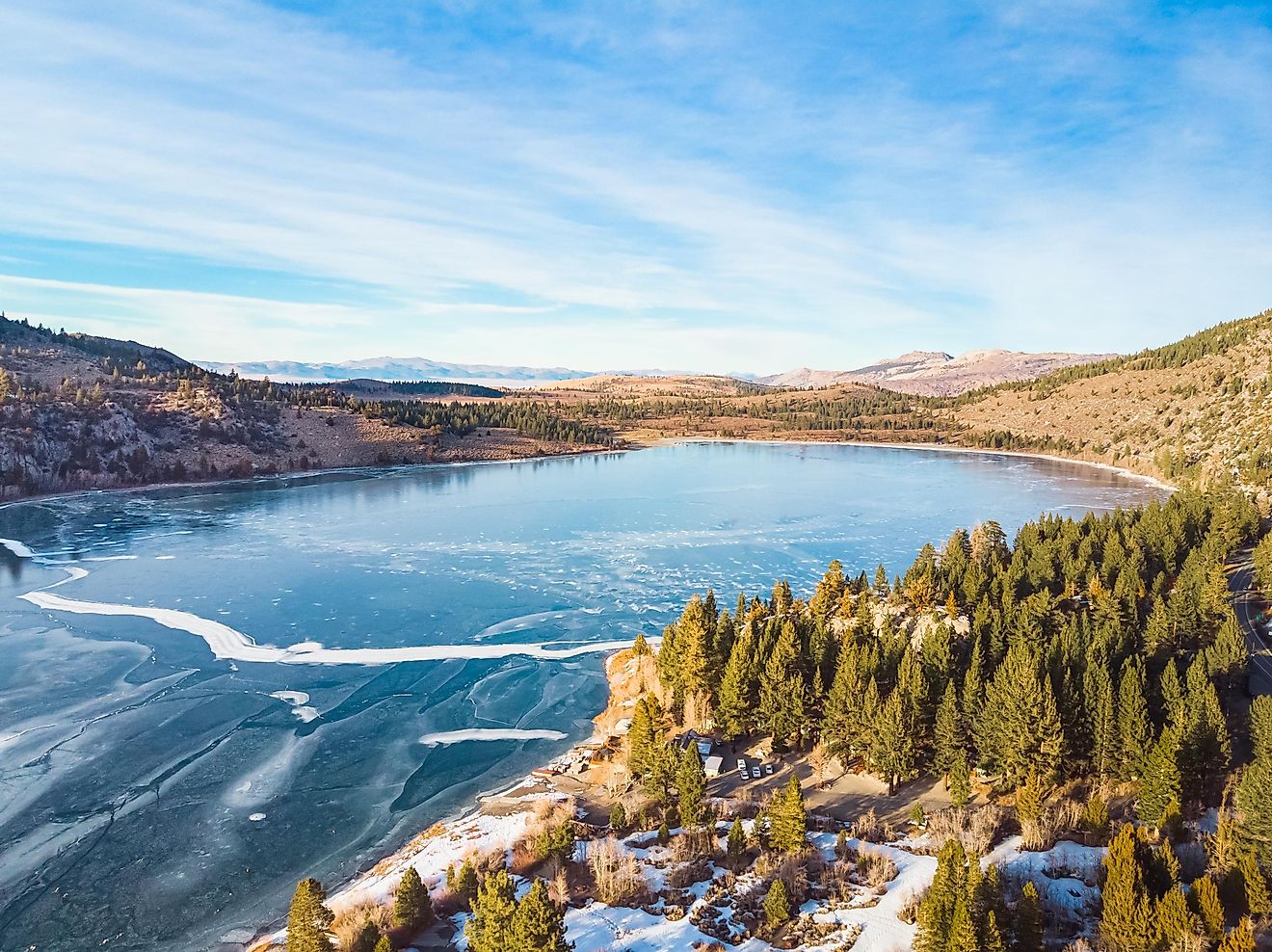 Aerial view of frozen June Lake, California, USA, with the town and surrounding mountains. Editorial credit: Kelli Hayden / Shutterstock.com