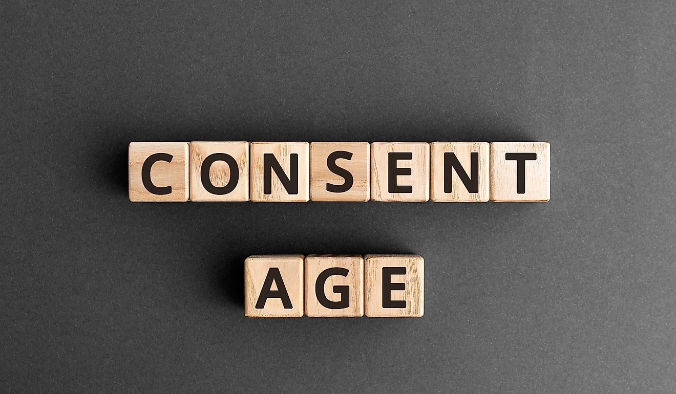 The words "Consent Age" formed from wooden blocks with letters.