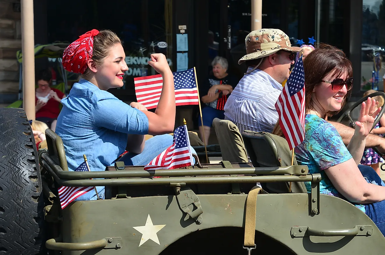 A parade participant recreating the iconic World War II image of Rosie the Riveter during a July 4th parade in Smyrna, Delaware. Editorial credit: The Old Major / Shutterstock.com