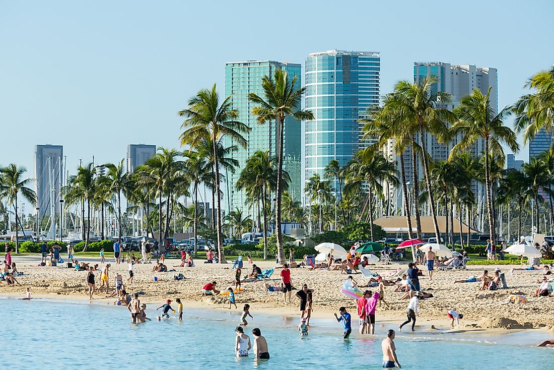 People swim at the beach in Honolulu. Editorial credit: Steve Heap / Shutterstock.com. 